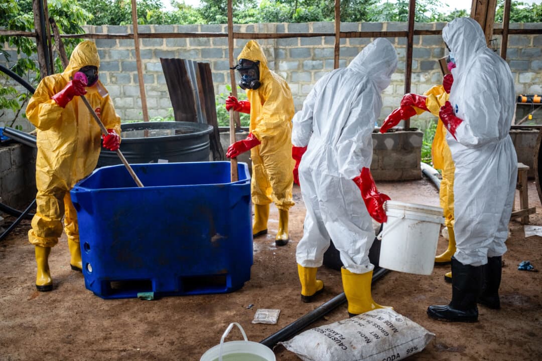 Staff from the forensic and chemical monitoring unit of Nigeria's National Drug Law Enforcement Agency perform a chemical neutralization process during an operation to dismantle an abandoned clandestine methamphetamine laboratory, in Iroto, Ogun State, Nigeria, on July 29, 2026. The abandoned site contained cooking cauldrons and vats of chemicals linked to a multimillion-dollar transnational meth operation. (Toyin Adedokun/AFP via Getty Images)