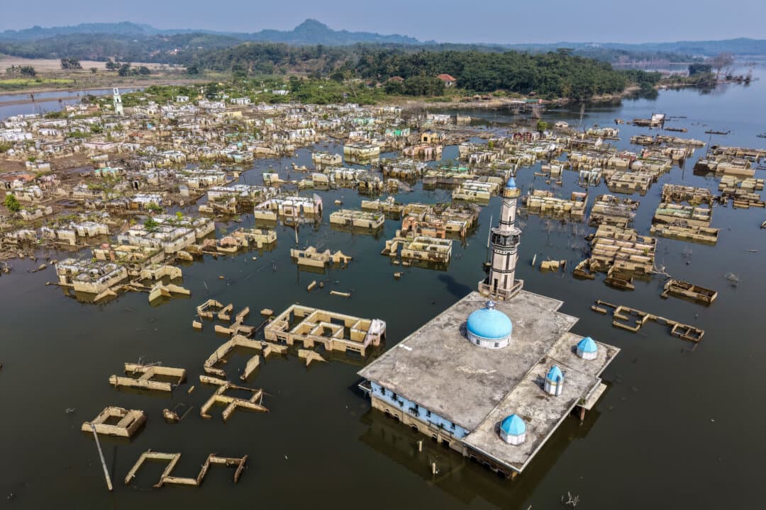 A mosque and surrounding buildings in Somang village is revealed by drought conditions in Lebak, Indonesia, on July 30, 2026, after having been deliberately flooded in 2023 for the construction of the Karian Dam. (Bay Ismoyo/AFP via Getty Images)