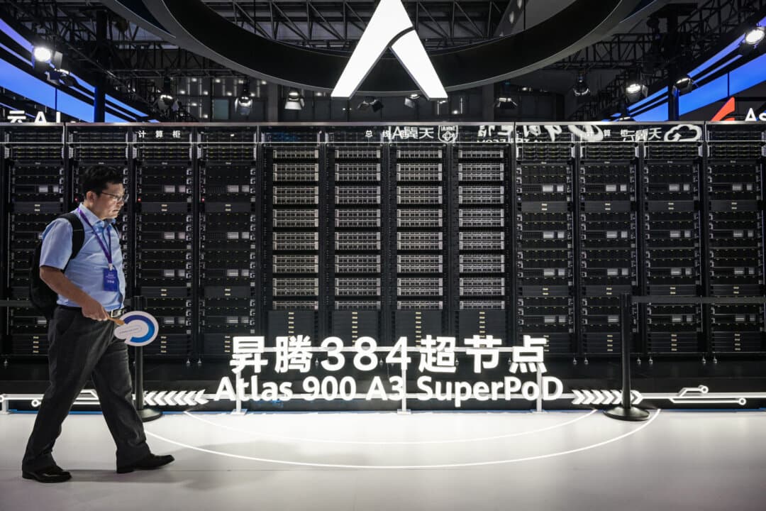 A person walks past a display of an Atlas 900 AI cluster at the Huawei stand during the World Artificial Intelligence Conference in Shanghai on July 28, 2025. Newsham said Chinese authorities see AI as a “battle,” in which they want to ensure America falls behind them and, ideally, becomes dependent on them. (Hector Retamal/AFP via Getty Images)