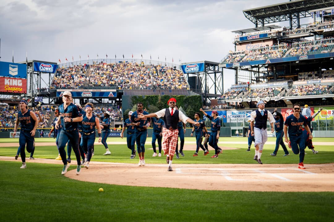 The Indianapolis Clowns run onto the field in Denver on Aug. 15, 2026. (Madalina Kilroy/The Epoch Times)