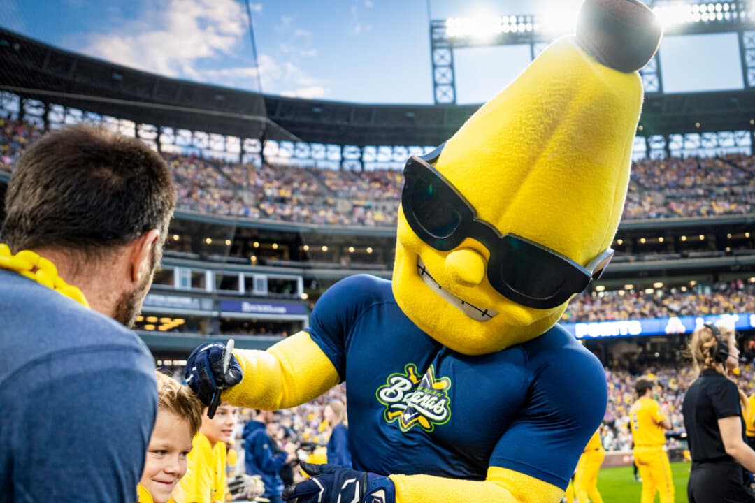 (Top Left) A chicken fight spills onto the field at a Savannah Bananas versus Indianapolis Clowns game in Denver on Aug. 15, 2026. (Top Center) Banana Ball fans stand for the national anthem as the game begins in Denver on Aug. 15, 2026. (Top Right) Dakota “Stilts” Albritton is on the mound during the Savannah Bananas versus Indianapolis Clowns game in Denver on Aug. 15, 2026. (Bottom Left) The Man-Nanas entertain Banana Ball fans in Denver on Aug. 15, 2026. (Bottom Center) Goofy antics at Coors Field in Denver on Aug. 15, 2026. (Bottom Right) Split, the official mascot of the Savannah Bananas, interacts with fans in Denver on Aug. 15, 2026. (Madalina Kilroy/The Epoch Times)