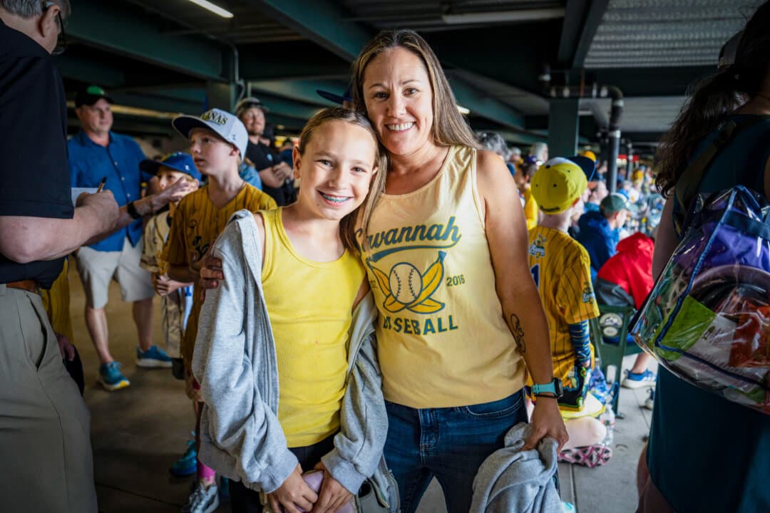Megan (R) and Mia Seacrist of Castle Rock, Colo. ahead of the Savannah Bananas versus Indianapolis Clowns game at Coors Field in Denver on Aug. 15, 2026. (Madalina Kilroy/The Epoch Times)