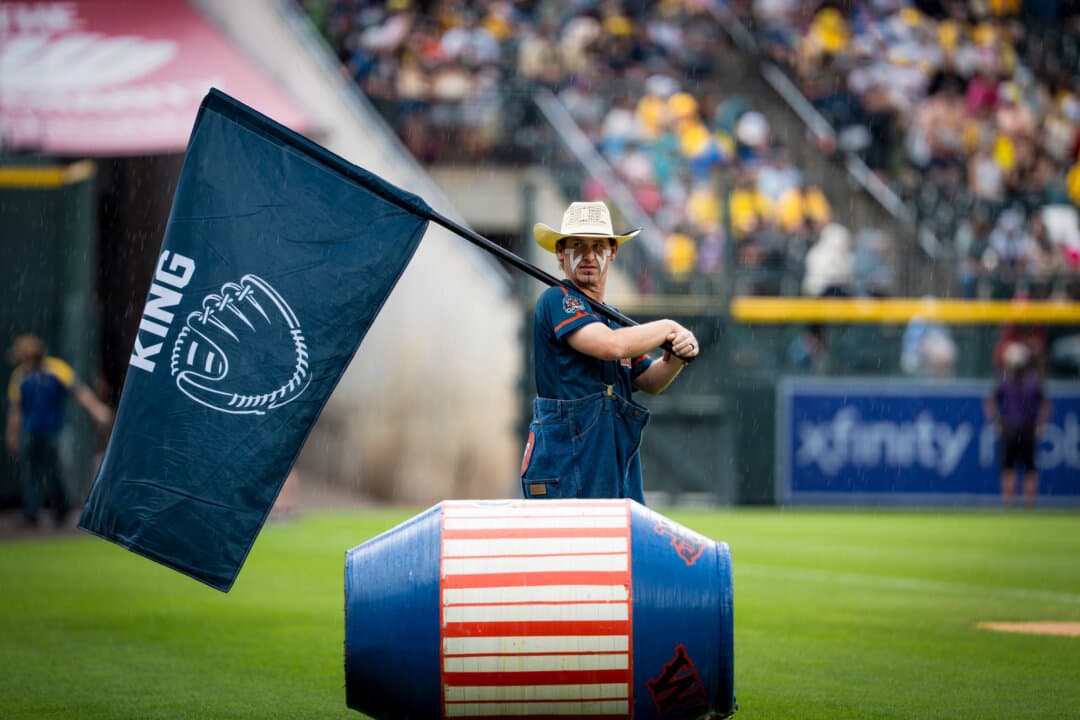 (Top) Former Major League Baseball standout Jackie Bradley Jr. ahead of the Savannah Bananas versus Indianapolis Clowns game at Coors Field in Denver on Aug. 15, 2026. (Bottom Left) Savannah Bananas player and entertainer Mat Wolf in his signature rodeo clown garb at Coors Field in Denver on Aug. 15, 2026. Wolf is a full-time Oklahoma City firefighter when he's not touring with the team. (Bottom Right) Indianapolis Clowns team members at Coors Field in Denver on Aug. 15, 2026. (Madalina Kilroy/The Epoch Times)