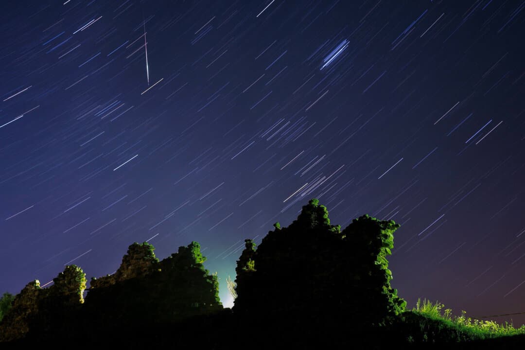 A long-exposure image captures the Perseid meteor shower streaking across the night sky above the ruins of a medieval castle in Kreva, Belarus, on Aug. 12, 2019. The annual meteor shower peaks each summer in the Northern Hemisphere. (Sergei Gapon/AFP via Getty Images)