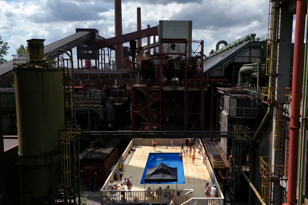 Visitors enjoy the water of the Werksschwimmbad pool at Zeche Zollverein in Essen, Germany, on Aug. 5, 2026. (Ina Fassbender/AFP via Getty Images)
