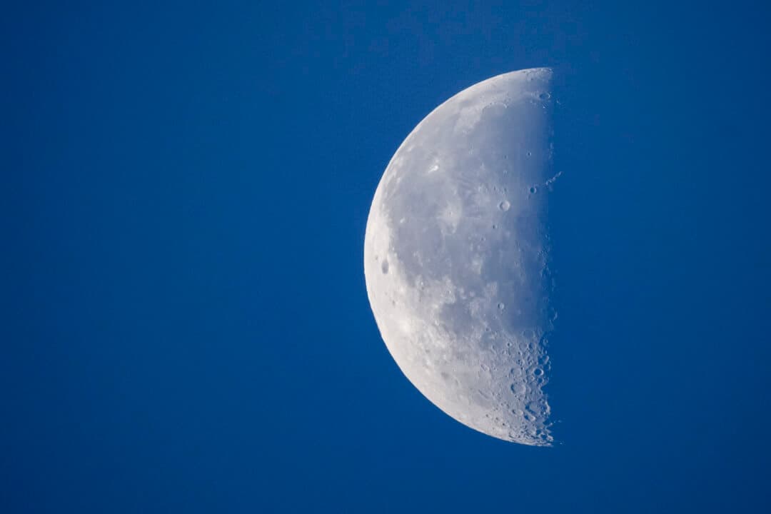 The moon in its third-quarter phase as seen from Lausanne, Switzerland, on Aug. 6, 2026. The surface is dramatically revealed by the low-angle sunlight that highlights craters and rugged terrain. (Fabrice Coffrini/AFP via Getty Images)