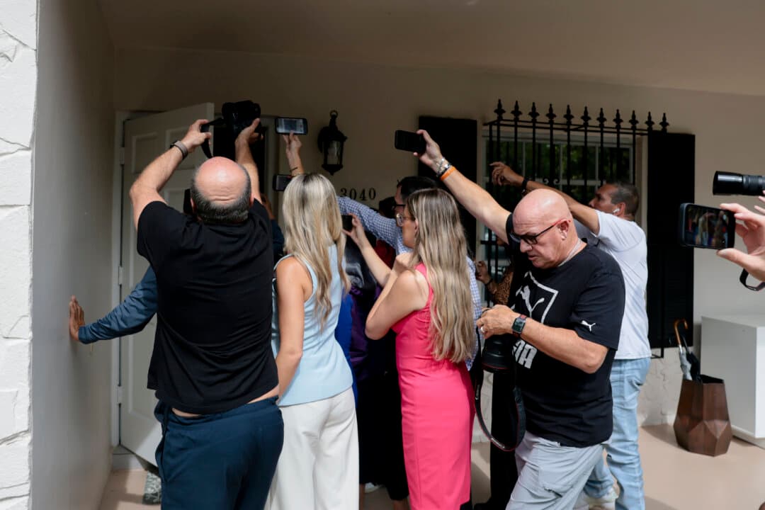 Members of the media crowd the front door on Aug. 5, 2026, as people enter the Westchester, Fla., home where Perez Hilton was found the previous day after he appeared to harm himself during a TikTok livestream. Hilton was hospitalized on Aug. 4 after Miami-Dade County sheriff’s deputies were dispatched to the home. (Joe Raedle/Getty Images)