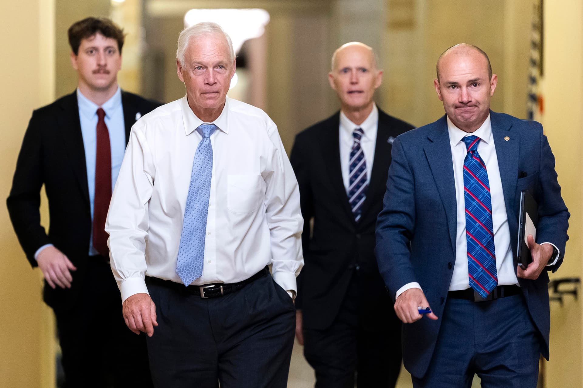 (L–R) Sen. Ron Johnson (R-Wis.), Sen. Rick Scott (R-Fla.), and Sen. Mike Lee (R-Utah) walk toward Senate Chambers in the U.S. Capitol Building in Washington on Aug. 7, 2026. (Finn Gomez/Getty Images)