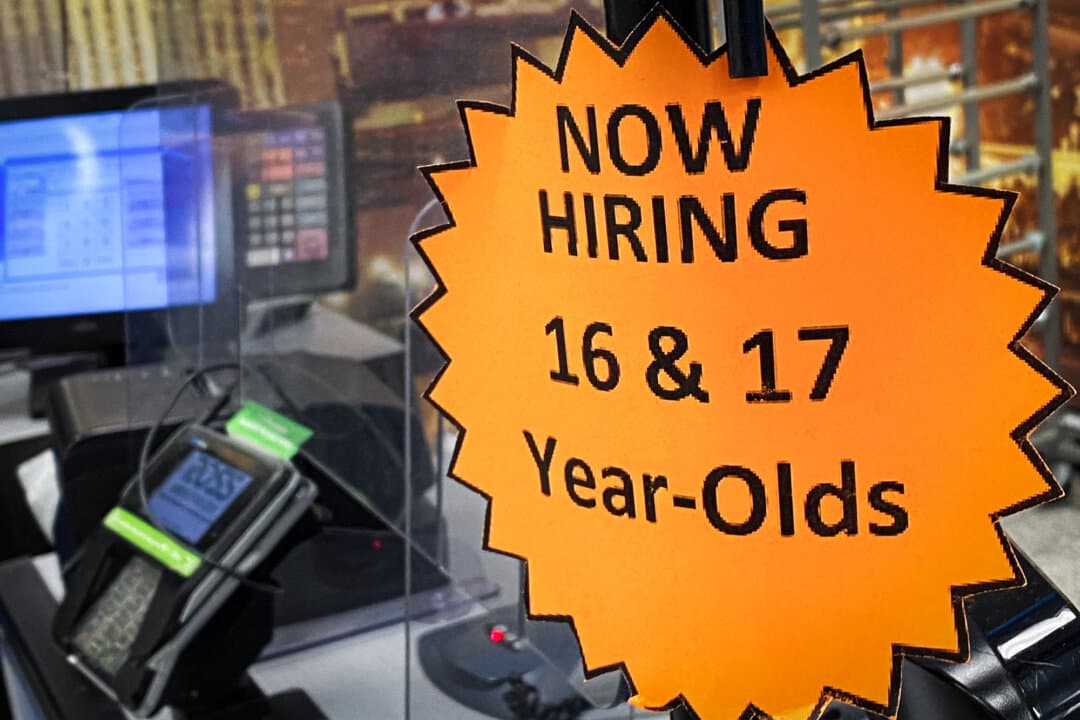 A hiring sign for 16- and 17-year-old employees is displayed on a cash register inside a discount department retail store in Las Vegas on May 7, 2022. (Patrick T. Fallon/AFP via Getty Images)