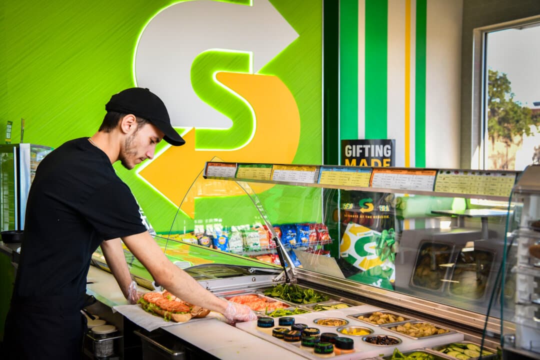 An employee works in a Subway restaurant in Crystal River, Fla., on Dec. 19, 2023. An outplacement firm has predicted work for youths this summer to fall to its worst pace in nearly 80 years. (Gerardo Mora/Getty Images for Subway)