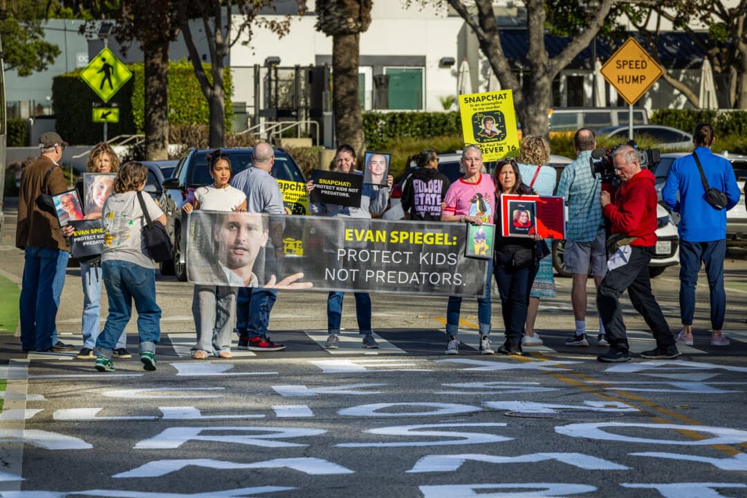 Demonstrators block a roadway near the offices of Snap Inc. in Santa Monica, Calif., on Feb. 12, 2026. Parents, including those who have lost children to accidental fentanyl poisonings linked to Snapchat, say a reckoning over youth safety on the platform is long overdue. (John Fredricks/The Epoch Times)