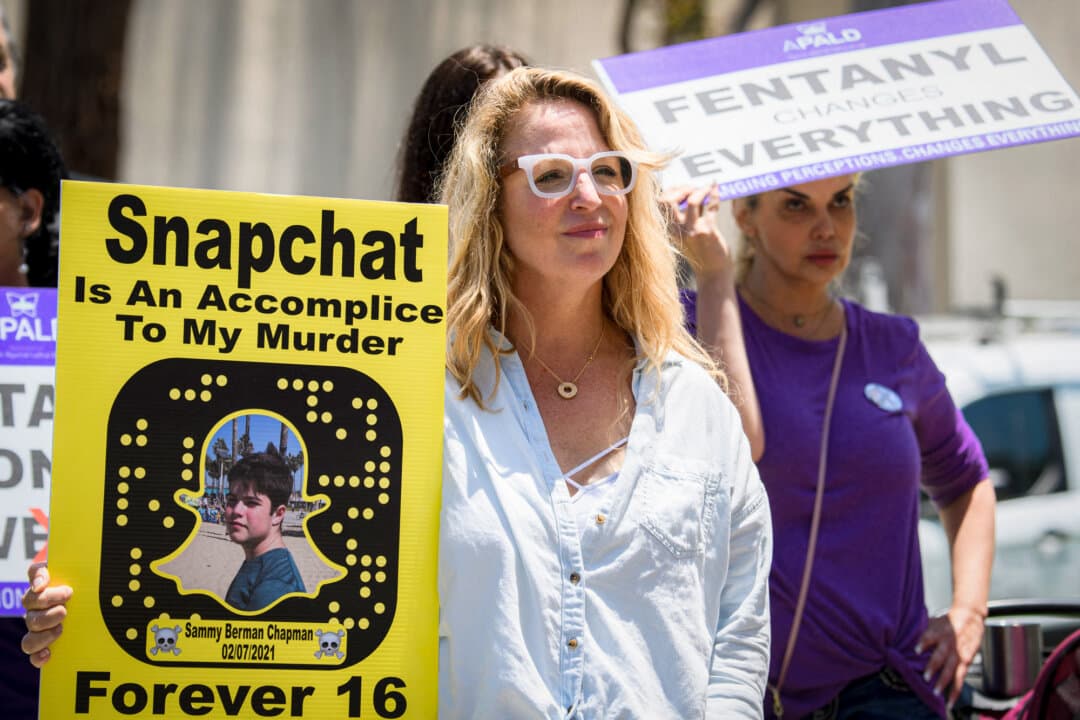 (Left) Laura Berman and her son Sammy, who died at age 16 after taking a fentanyl-laced pill he purchased on Snapchat, pose in this file image. (Right) Laura Berman (L) carries a photo of her son as she protests with family and friends of people who died after being poisoned by pills containing fentanyl, near the Snap, Inc. headquarters in Santa Monica, Calif., on June 4, 2021. (Courtesy of Samuel Chapman, Patrick T. Fallon/AFP via Getty Images)