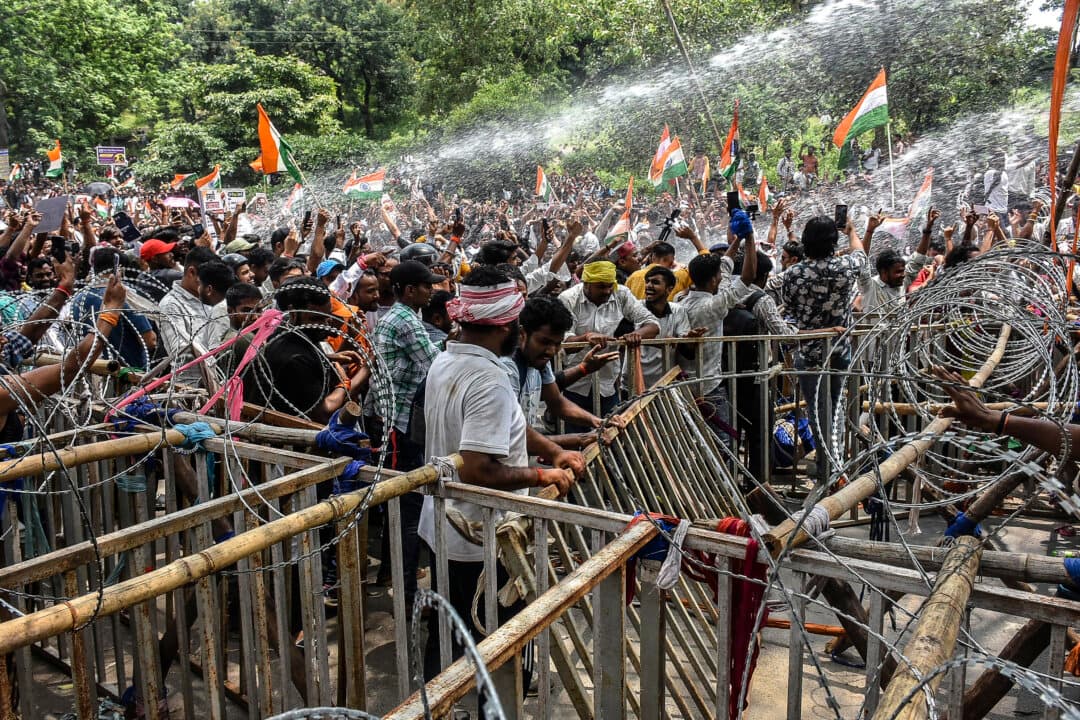 Police personnel use water cannon to disperse demonstrators during a protest against alleged irregularities in the Jharkhand Public Service Commission and Jharkhand Staff Selection Commission recruitment exams in Ranchi, India, on Aug. 10, 2026. Indian students marched toward the state assembly in Jharkhand on Aug. 10, escalating protests over government recruitment examinations, with several students also on hunger strike. (Rajesh Kumar/AFP via Getty Images)