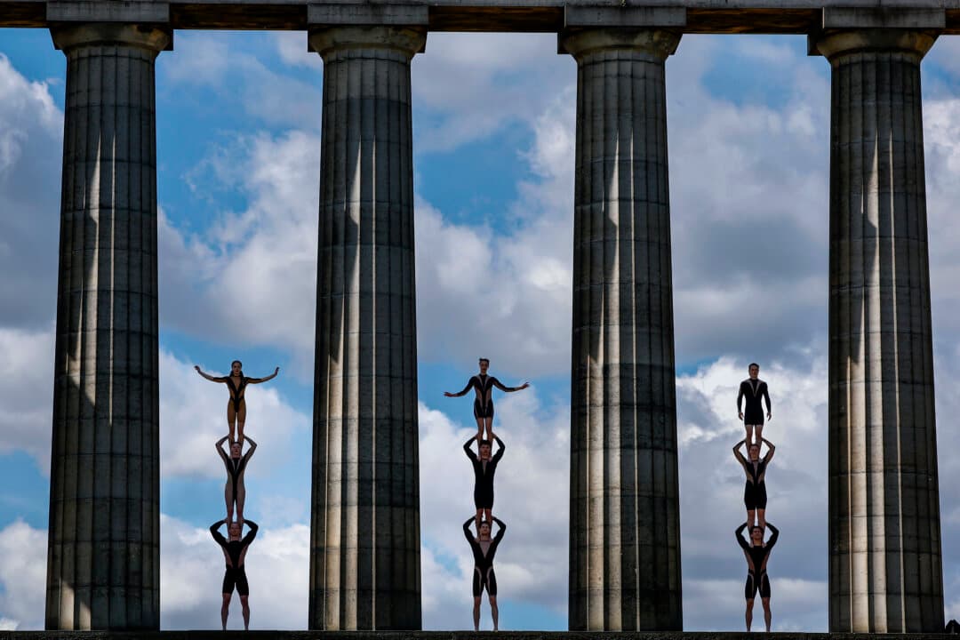Performers of Circa Wolf, which is being performed at Underbelly Circus Hub on the Meadows hold a photocall on Calton Hill in Edinburgh, Scotland, on Aug. 10, 2026. For three weeks each August, Edinburgh welcomes an explosion of creative energy from around the globe as artists and performers take part in the Edinburgh Fringe Festival, presenting shows that span many genres including cabaret, children's shows, comedy, dance, physical theatre, circus, music, musicals, opera and theatre. (Jeff J Mitchell/Getty Images)