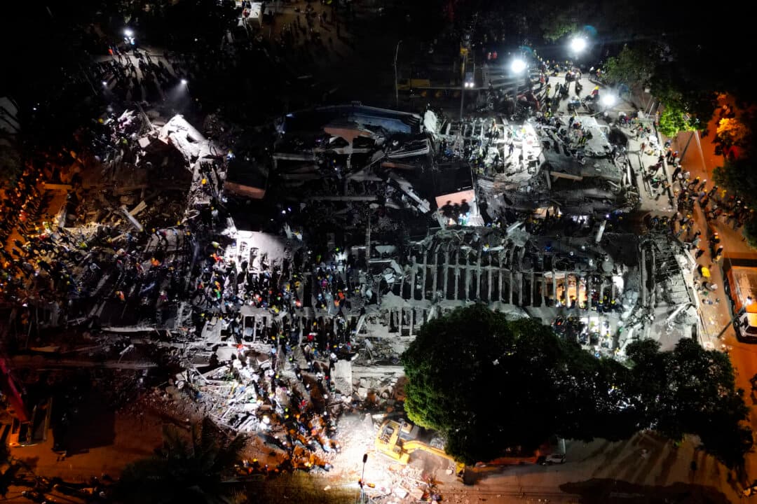 Rescue workers and volunteers searching for survivors at the site of collapsed buildings after an earthquake in Cali, Colombia, on Aug. 12, 2026. Rescuers, soldiers and volunteers searched through collapsed apartment blocks and office buildings across western Colombia, racing to find survivors after the country's strongest earthquake in a century killed at least 239 people and left many more homeless on Aug. 10. (Raul Arboleda/AFP via Getty Images)