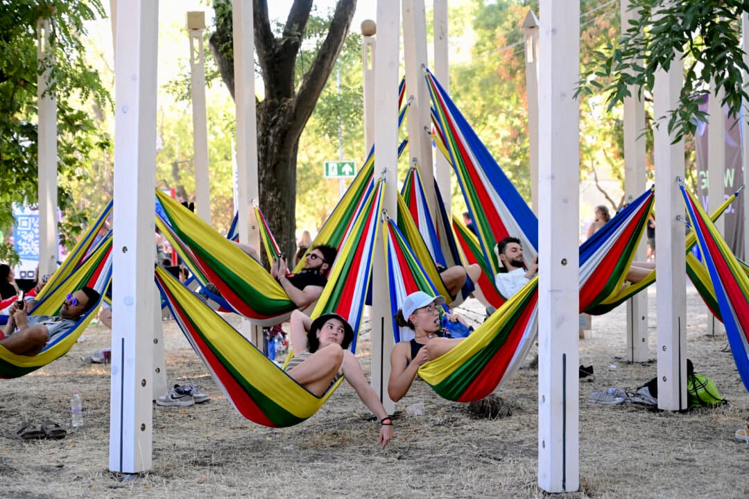 People relax on colorful hammocks during the Sziget Festival at Obuda Island, in Budapest, Hungary, on Aug. 13, 2026. The 33rd Sziget Festival will take place from Aug. 11 to 15. (Attila Kisbenedek/AFP via Getty Images)