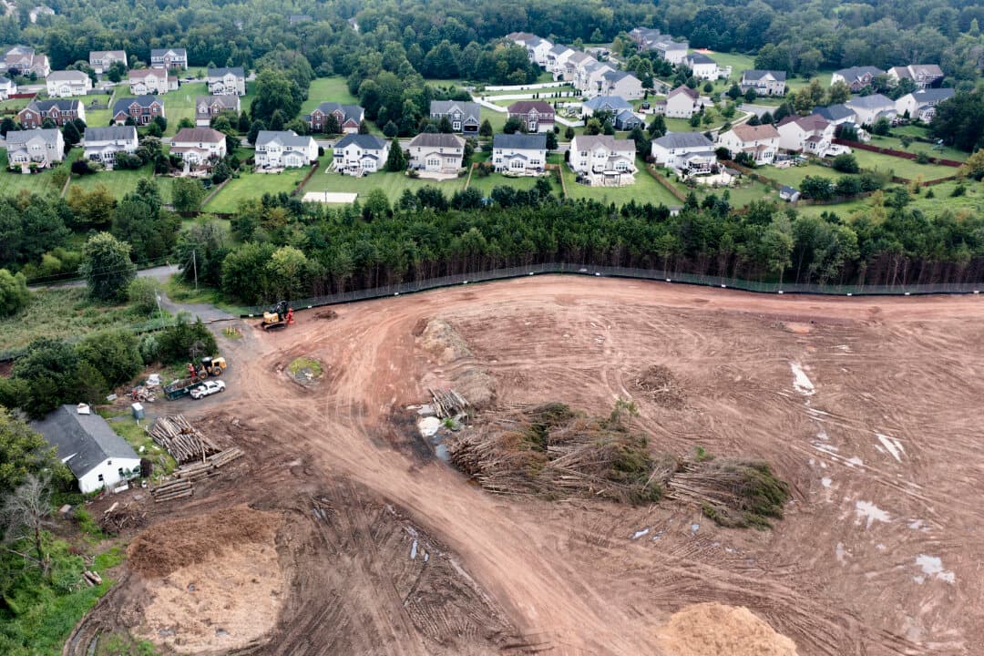 Single-family homes adjacent to a lot being cleared to build a new data center in Stone Ridge, Va., on Aug. 12, 2026. Hastily built to meet skyrocketing demand for computing power required by the global artificial intelligence race, data centers are facing opposition across the United States. (Brendan Smialowski/AFP via Getty Images)