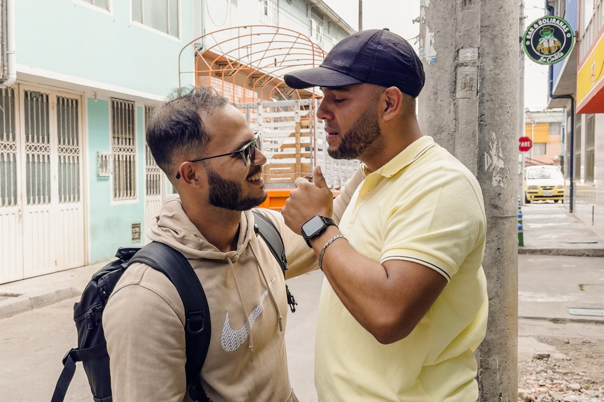 Venezuelan brothers Carlos José Leon (L) and Yarvis Hoyos greet each other for the first time in nearly nine years. In 2018, Leon fled Venezuela to live in Brazil and Hoyos fled to Colombia, in Bogotá, Colombia, on July 5, 2026. (Frederico Vidovix/The Epoch Times)