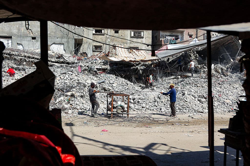 Salvage workers scrap steel rods from the rubble of a building that was destroyed during Israel's war against the Hamas terrorist group in the Gaza Strip, to use the recycled remains in the future, in Gaza City, Gaza Strip, on Aug. 16, 2026. (Omar Al-Qattaa/AFP via Getty Images)