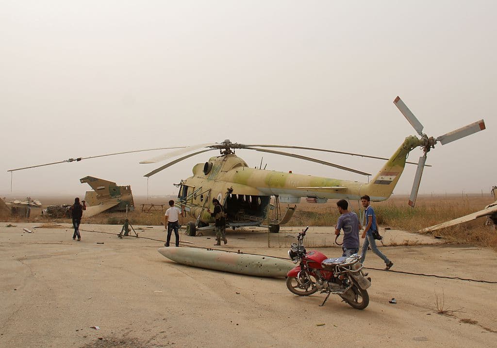 Journalists take photos of members of Al-Qaeda's Syrian affiliate and its allies after they seized the Abu Duhur military airport in northwestern Idlib province on Sept. 9, 2015. (Omar Haj Kadour/AFP Photo)