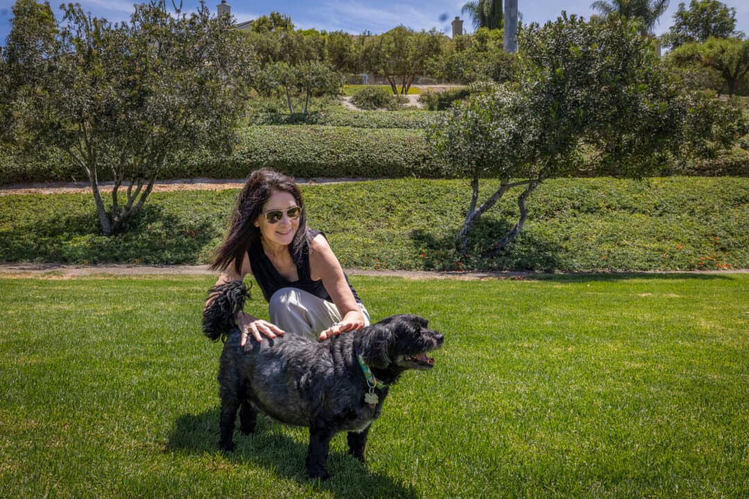 Liesal Heidt plays with her dog in Ladera Ranch, Calif., on July 24, 2026. As their concerns about herbicide spraying mounted over the years, Ladera residents have kept a running list, currently around 43 incidents of canine cancer. (John Fredricks/The Epoch Times)