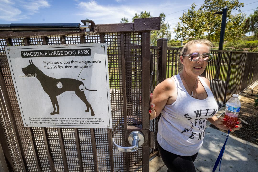 Courtney Harris exits a dog park in Ladera Ranch, Calif., on July 24, 2026. Harris said after her family moved to Ladera in 2019, both of her dogs came down with mysterious seizure conditions after eating grass outside her apartment complex. (John Fredricks/The Epoch Times)