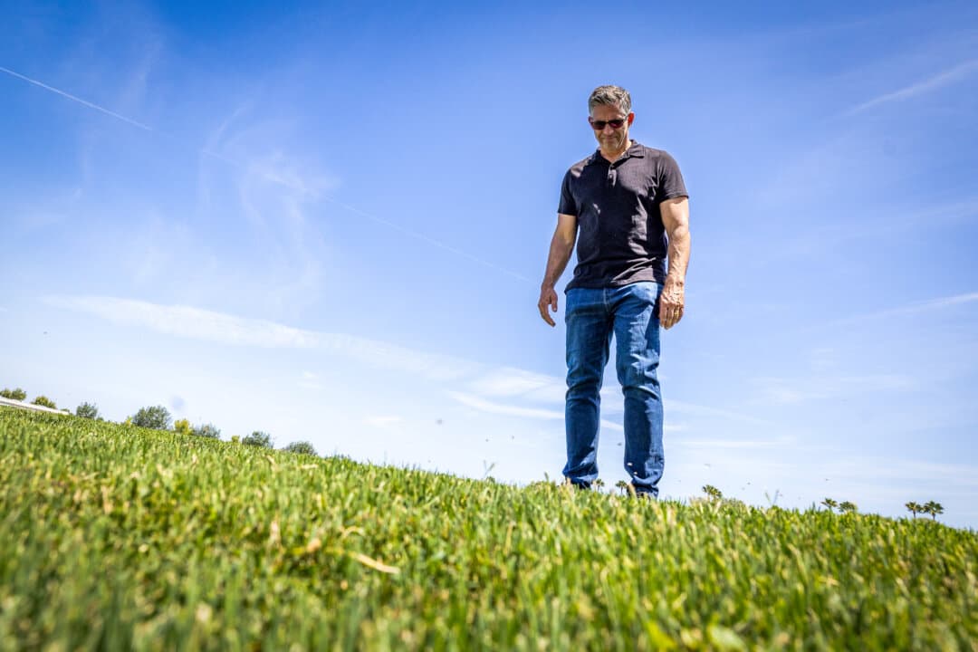 John Gresko, a member of Ladera Ranch’s civic council who has helped organize recent demands to end heavy pesticide use, looks at landscaped grass in Ladera Ranch, Calif., on July 24, 2026. (John Fredricks/The Epoch Times)