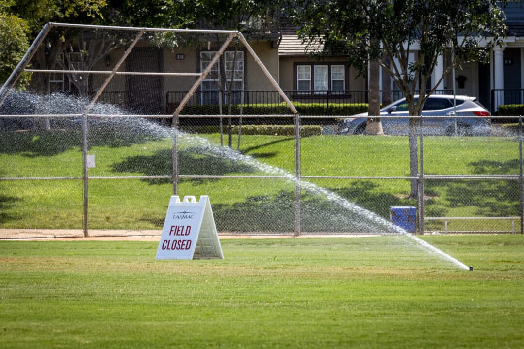 A closed park is being watered in Ladera Ranch, Calif., on July 24, 2026. (John Fredricks/The Epoch Times)
