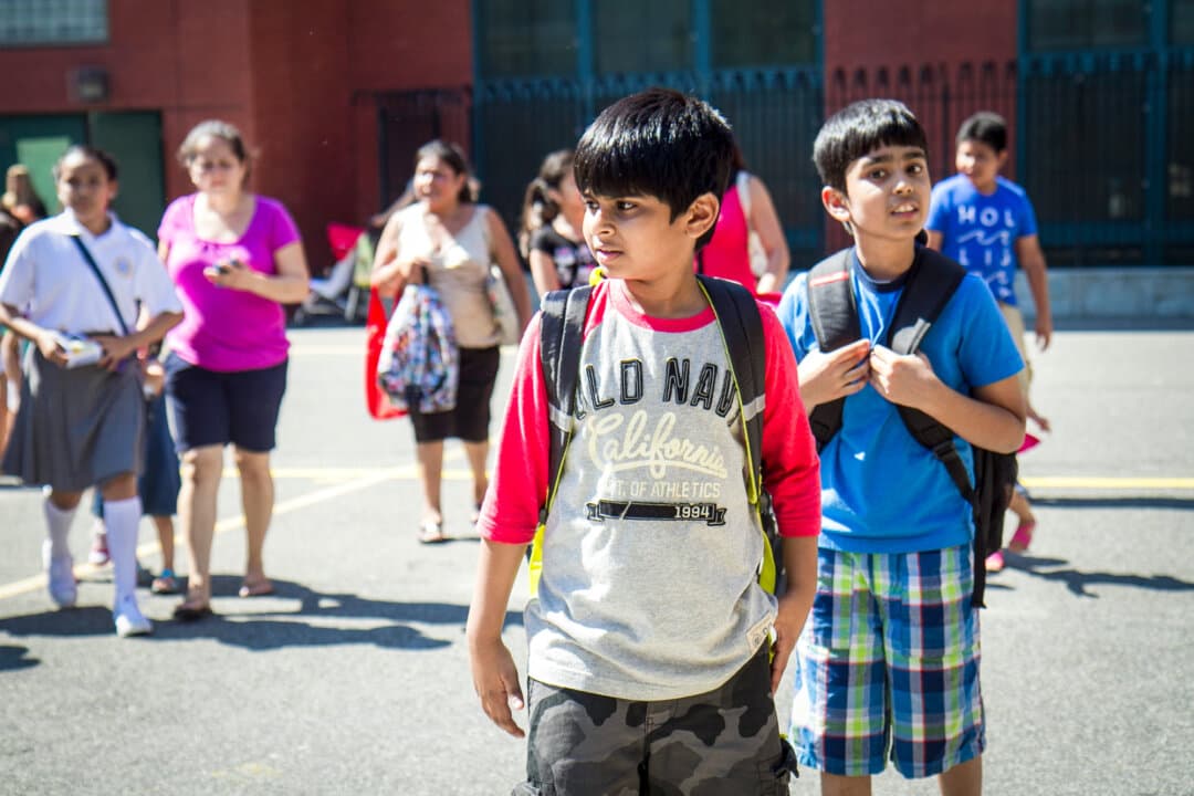 Students leave P.S. 234 after their first day of school in Astoria, New York City on Sept. 4, 2014. New York state legislators are still considering a measure providing 30 minutes of daily recess to students in grades K-6. (Samira Bouaou/The Epoch Times)