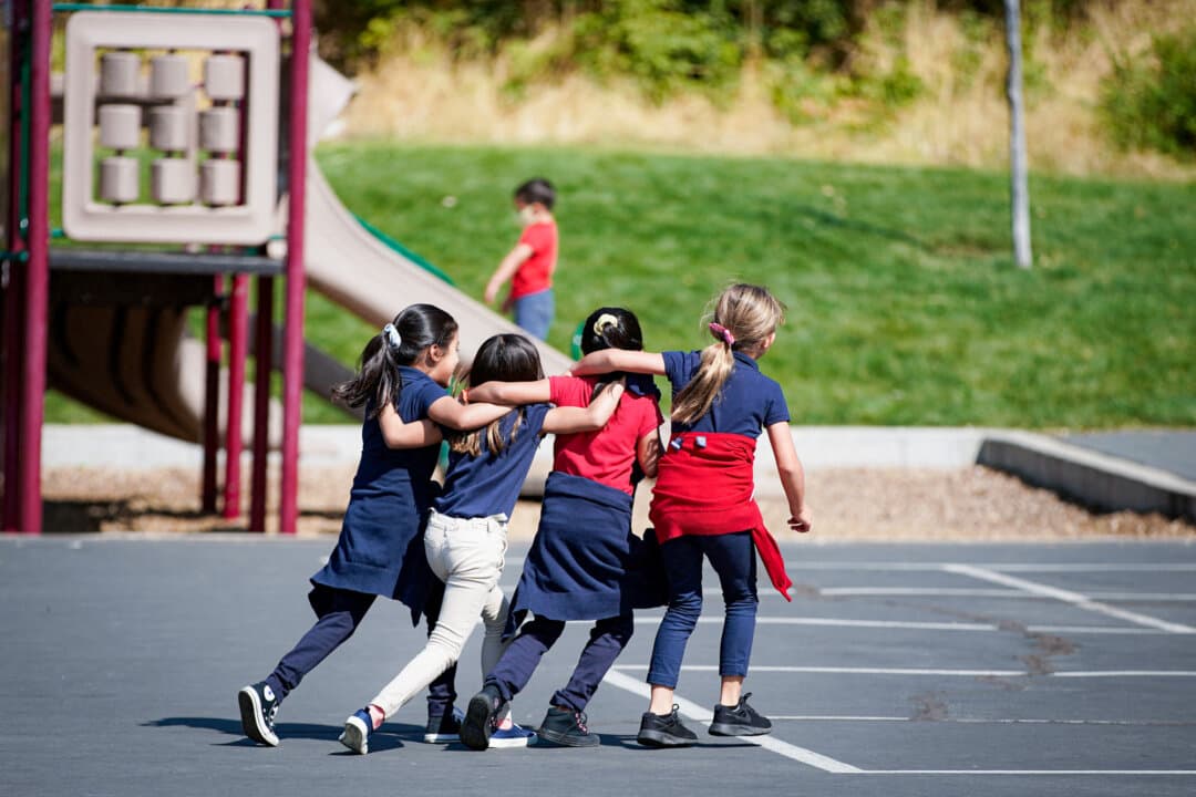 Students run and play on the playground at Freedom Preparatory Academy in Provo, Utah, on Sept. 10, 2020. In May, the American Academy of Pediatrics updated its guidance on school recess, calling for multiple 20-minute breaks per day. (George Frey/AFP via Getty Images)