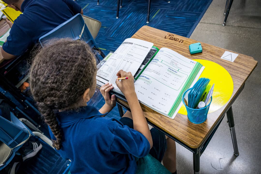A student studies in a classroom in Nevitt Elementary School in Phoenix on Oct. 26, 2022. Research suggests higher academic achievement and improved mental health in children who attend schools with more free play time between blocks of instruction. (Olivier Touron/AFP via Getty Images)