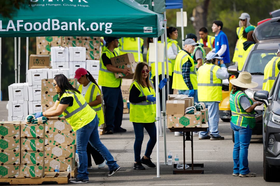 Workers and volunteers help distribute food boxes at a drive-through food distribution facility, in response to a federal government shutdown and Supplemental Nutrition Assistance Program/CalFresh food benefits delays, in City of Industry, Calif., on Nov. 5, 2025. (Mario Tama/Getty Images)