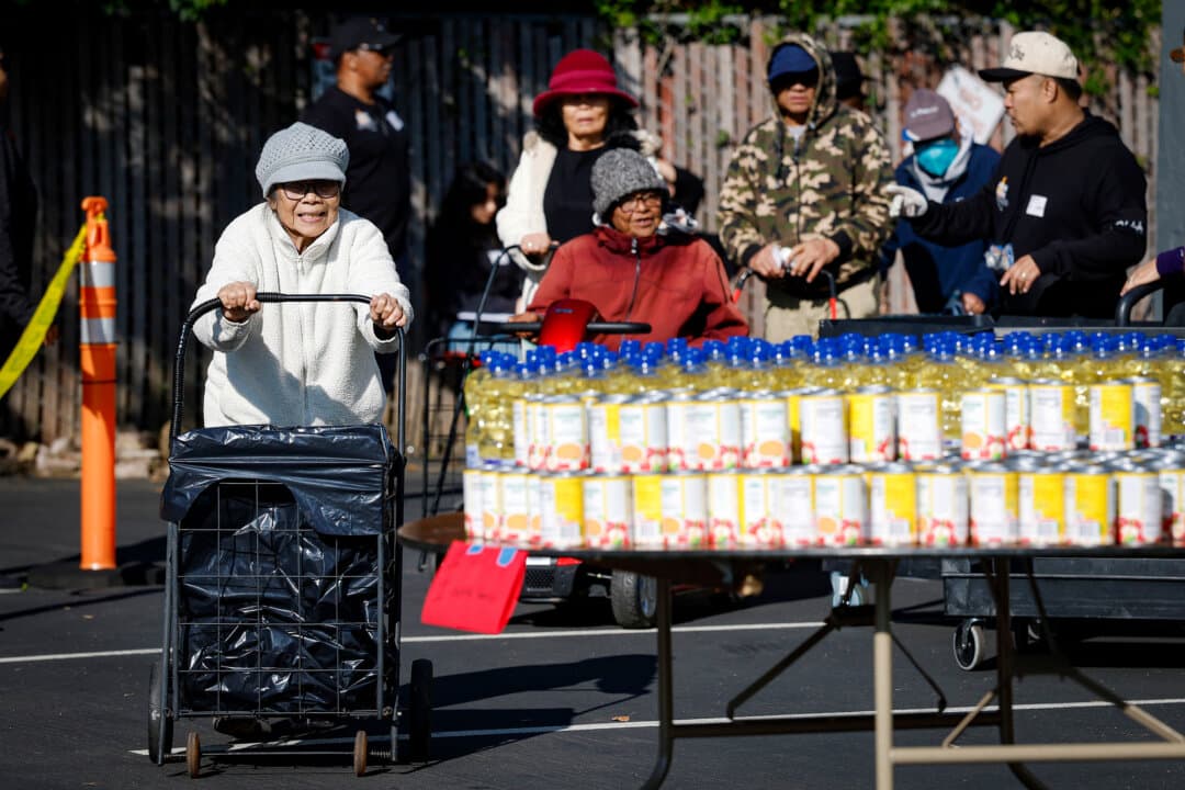 People line up to receive free food during a Thanksgiving food giveaway at Shiloh Mercy House in Oakland, Calif., on Nov. 24, 2025. (Justin Sullivan/Getty Images)