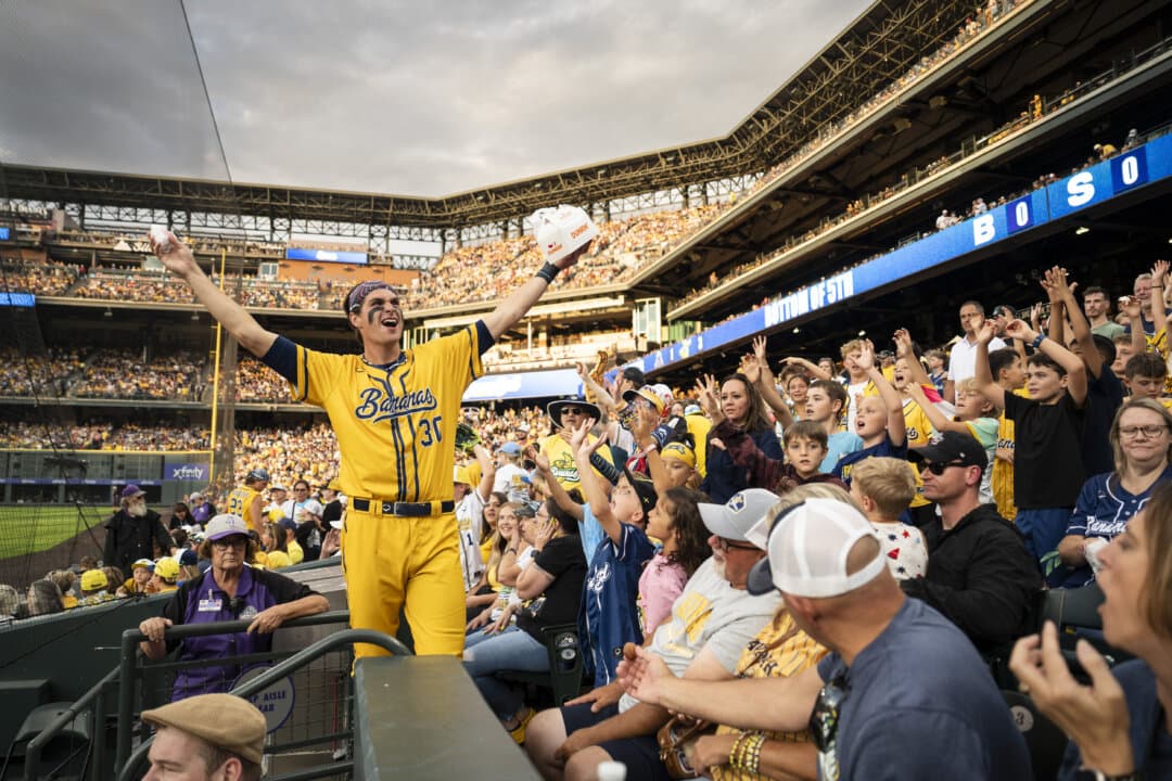 Banana Ball player Connor Harris interacts with fans during the Savannah Bananas vs. Indiana Clowns game at Coors Field in Denver on Aug. 15, 2026. (Madalina Kilroy/The Epoch Times)