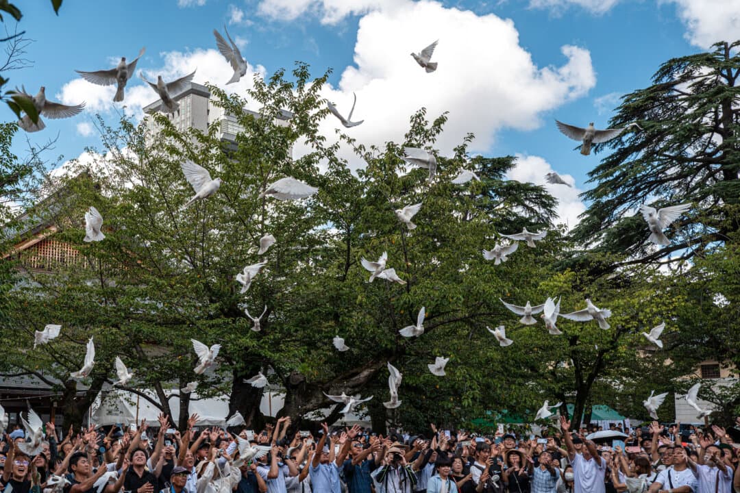 People release white doves, a symbol of peace, as a tribute to the war dead at the Yasukuni Shrine on the 81st anniversary of Japan's surrender in World War II, in Tokyo on Aug. 15, 2026. (Philip Fong/AFP via Getty Images)