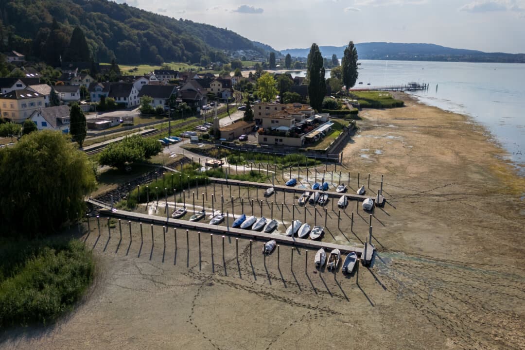 A floating jetty and boats stranded on the dried-up shores of the Untersee, also known as Lower Lake Constance, during a heatwave in Mannenbach, Switzerland, on Aug. 15, 2026. (Fabrice Coffrini/AFP via Getty Images)