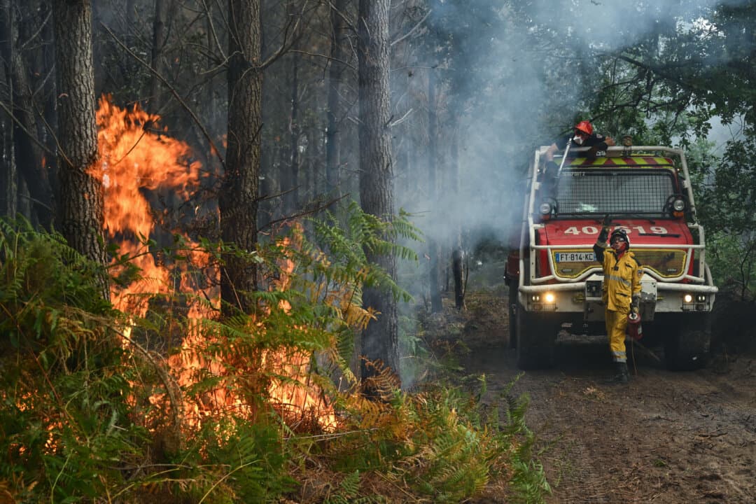 Crews battling a wildfire light firebreaks near a farm in Luglon, France, on Aug. 16, 2026. (Gaizka Iroz/AFP via Getty Images)