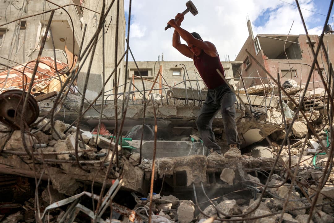 A salvage worker breaks the rubble of a building that was destroyed during Israel's war against Hamas in Gaza City on Aug. 16, 2026. (Omar AL-QATTAA/AFP via Getty Images)