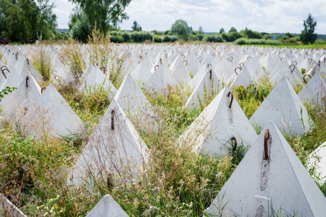 Dragon's teeth—concrete obstacles designed to impede the movement of military vehicles—stand ready during a visit by Latvia's president to inspect the border with Belarus, in Piedruja, Latvia, on Aug. 17, 2026. (Gints Ivuskans/AFP via Getty Images)