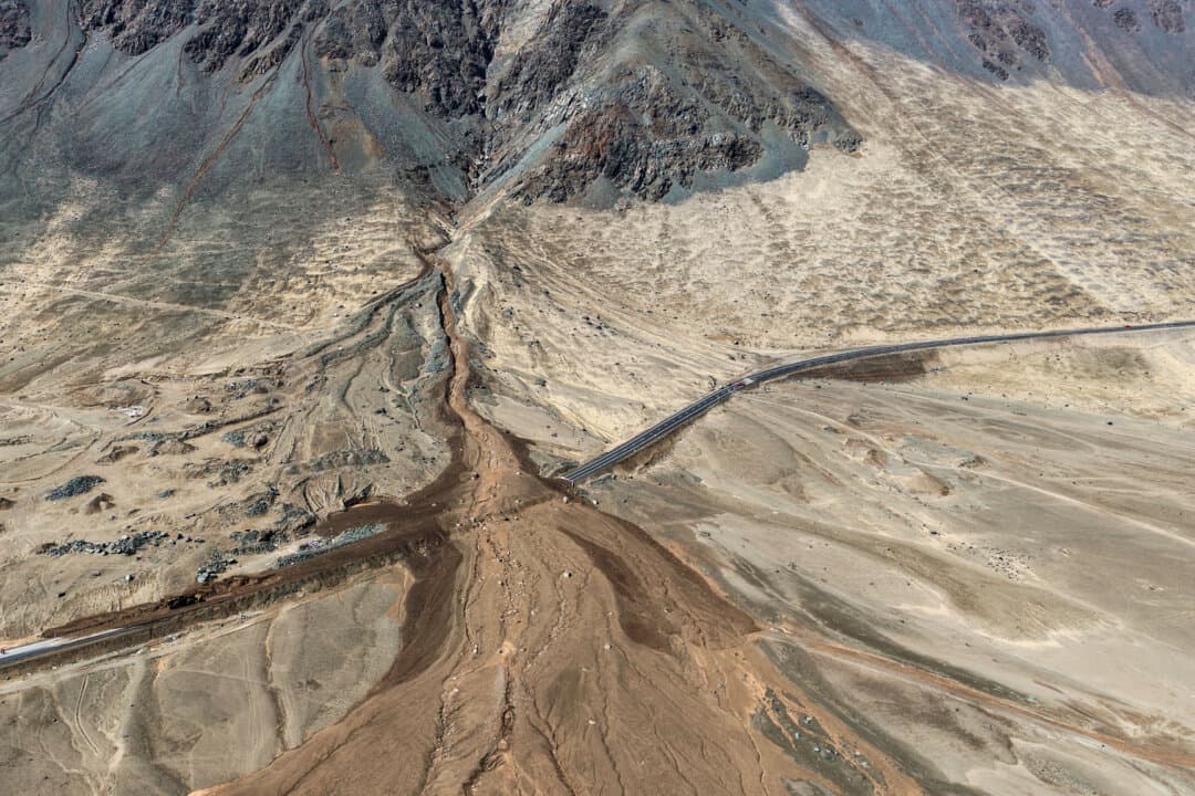 A highway is covered with mud and debris after a landslide caused by heavy rainfall in Iquique, Chile, on Aug. 19, 2026. (Alex Diaz/AFP via Getty Images)