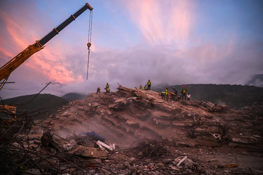 Rescue workers search the rubble of collapsed buildings following the June 24 earthquakes along the coast in Caraballeda, Venezuela, on Aug. 19, 2026. Nearly two months after the disaster, relatives and rescuers continue searching for people. The earthquakes destroyed at least 190 buildings. (Juan Barreto/AFP via Getty Images)
