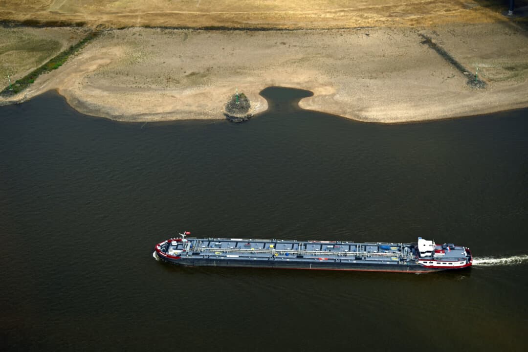 A vessel sails past the partially dried-up riverbed of the Rhine following exceptionally hot weather in Düsseldorf, Germany, on Aug. 20, 2026. (Ina Fassbender/AFP via Getty Images)