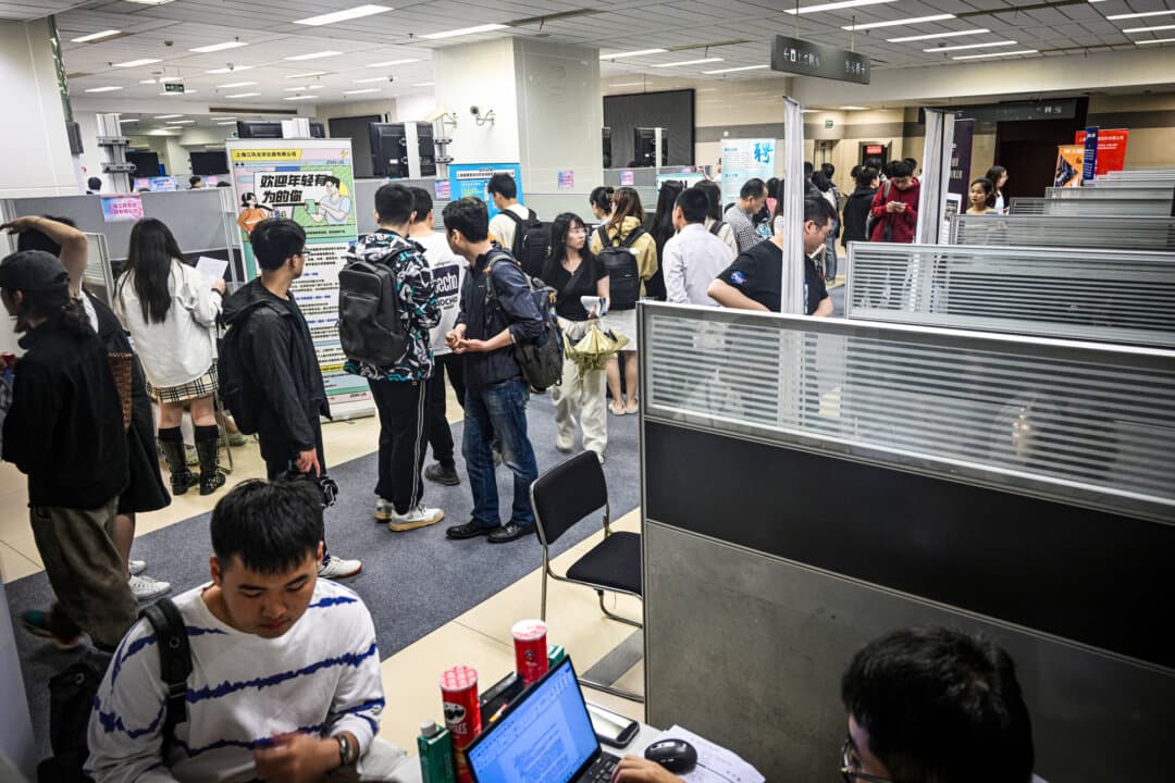 People visit a job fair in the Jing'an District in Shanghai on June 5, 2024. With many multinational corporations cutting costs, job seekers in China are under pressure. (Hector Retamal/AFP via Getty Images)