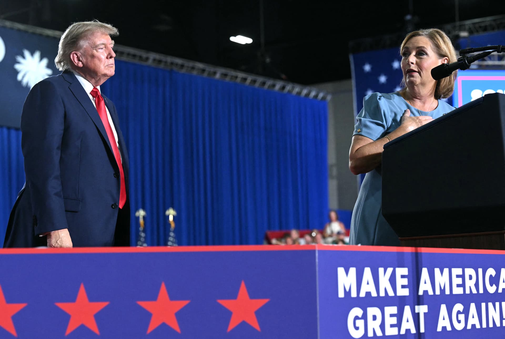 President Donald Trump listens to Sen. Darline Graham (R-S.C.) speak during a campaign rally at Myrtle Beach Convention Center in Myrtle Beach, S.C., on Aug. 21, 2026. (Saul Loeb/AFP via Getty Images)