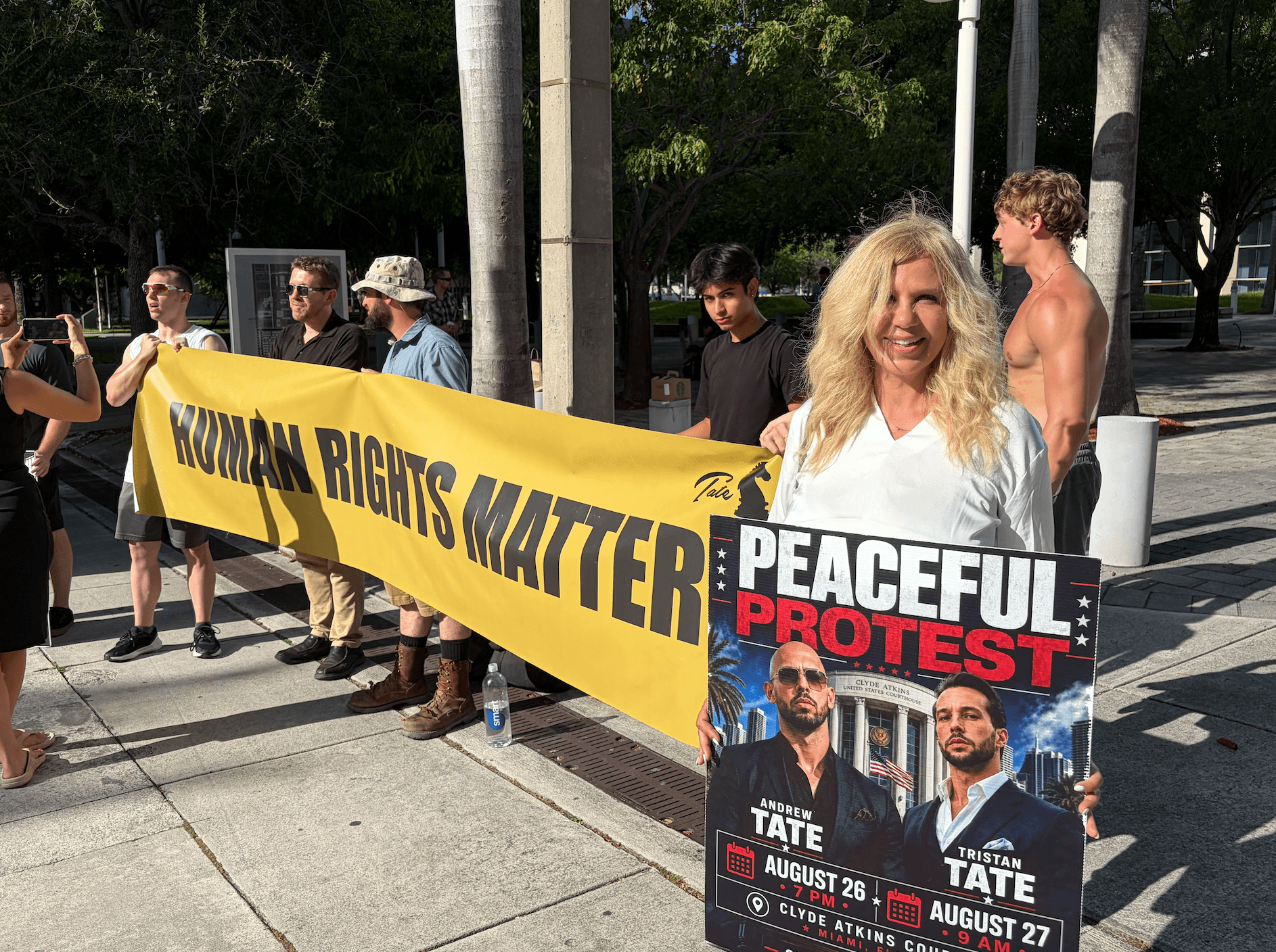 Azenath Gregoire traveled from California to South Florida in support of the Tate brothers. She said the social media stars have influenced her life in a tremendous way, while standing outside the Miami federal courthouse on Aug. 27, 2026. (Troy Myers/Epoch Times)