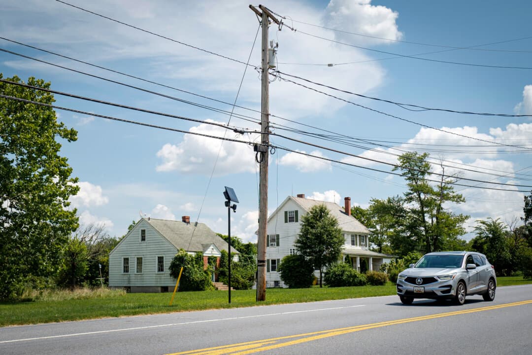 A Flock Safety license plate reader in a neighborhood in Jessup, Md., on Aug. 26, 2026. Jessup straddles two counties: Howard County, which does not employ Flock Safety cameras, and Anne Arundel County, which does use the cameras. (Madalina Kilroy/The Epoch Times)