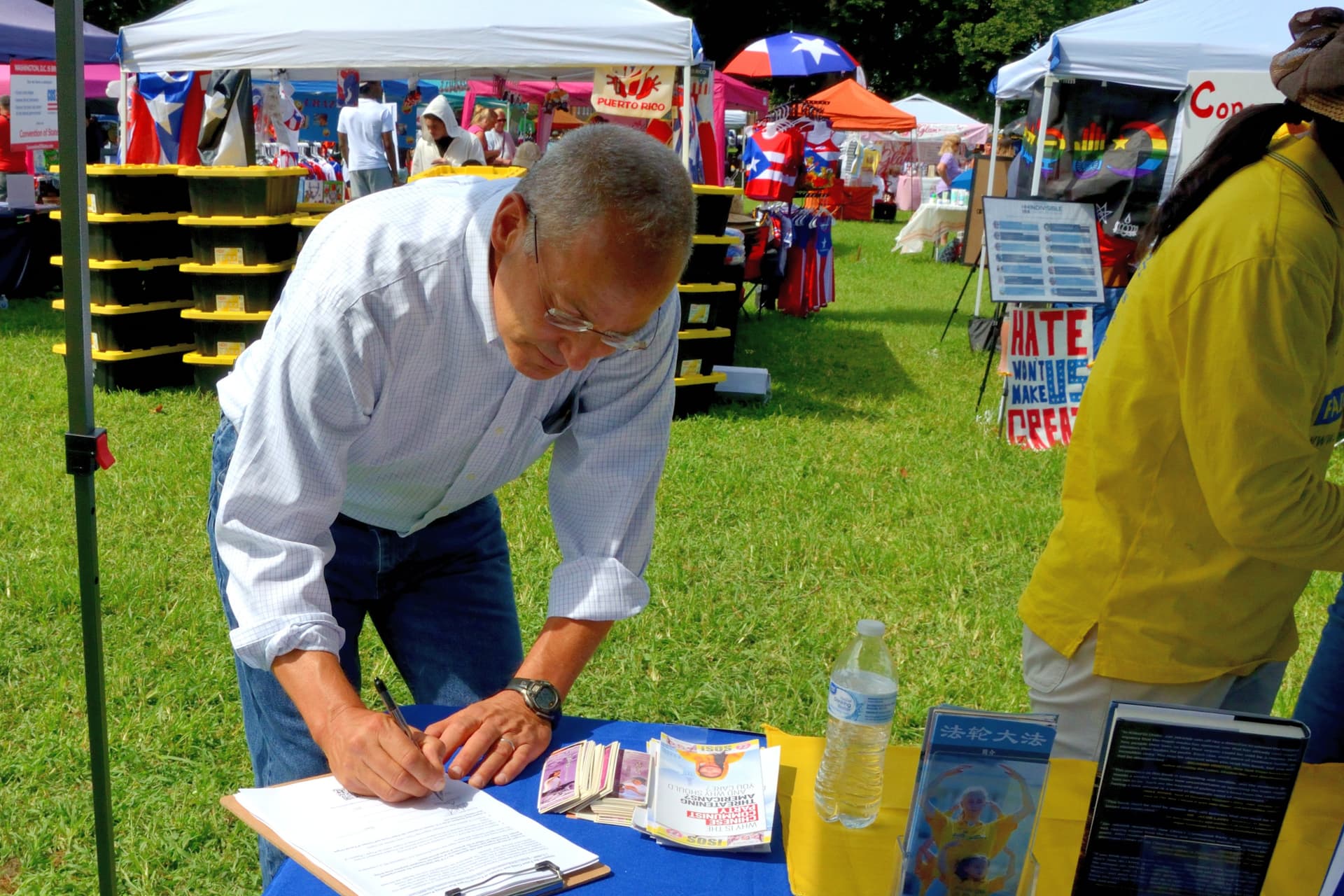 Dr. Mike Katz, a Republican candidate for the U.S. Senate from Delaware, signs a petition in support of S.4009, the Falun Gong and Victims of Forced Organ Harvesting Protection Act, at the 4th annual Baila Con Dover Latin Festival on Aug. 29, 2026. (Frank Liang/The Epoch Times)