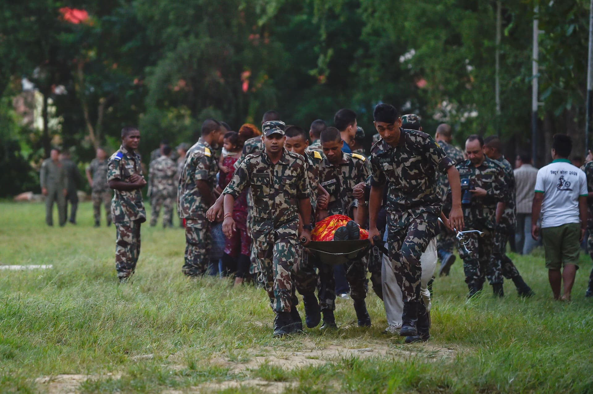 Army personnel carry a person on a stretcher at an army rescue camp in Trishuli Batar, Nepal, on Aug. 27, 2026. Hundreds were reported missing after a sudden flood swept through the Bhote Koshi River basin in northern Rasuwa on Aug. 26. (Ritesh Shukla/Getty Images)