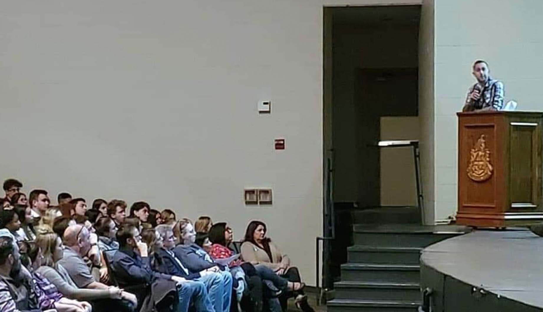 Caleb Trahan speaks to high school students about the dangers of driving while fatigued. (Courtesy of 8 Madison England)