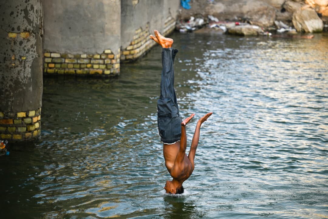 A young Iraqi dives into the Shatt al-Arab River amid soaring temperatures, in Basra, Iraq, on Aug. 31, 2026. (Hussein Faleh/AFP via Getty Images)